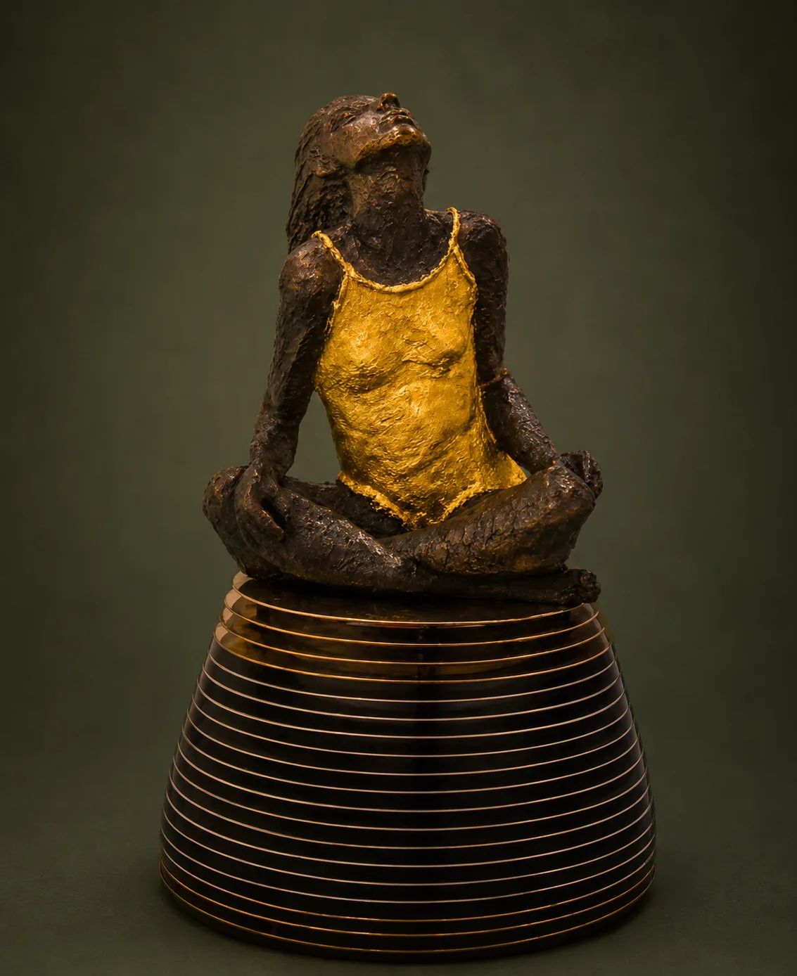 Figure on pedestal sculpture made from mixed metal elements.